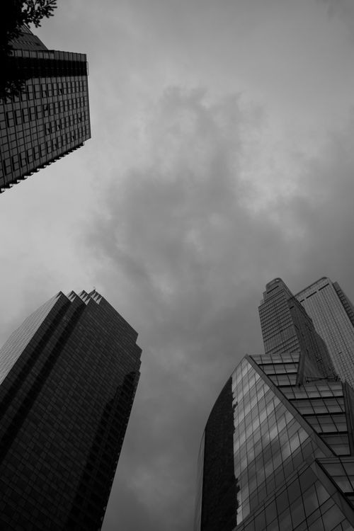 Free Dramatic low angle shot of New York's modern skyscrapers against a cloudy sky. Stock Photo