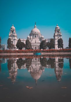 Stunning reflection of Victorian architecture in a calm pond in Kolkata, India.