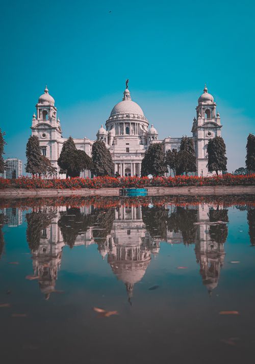 Free Stunning reflection of Victorian architecture in a calm pond in Kolkata, India. Stock Photo