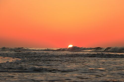 Free Captivating sunrise over the Atlantic Ocean at Hilton Head Island with vibrant orange skies. Stock Photo