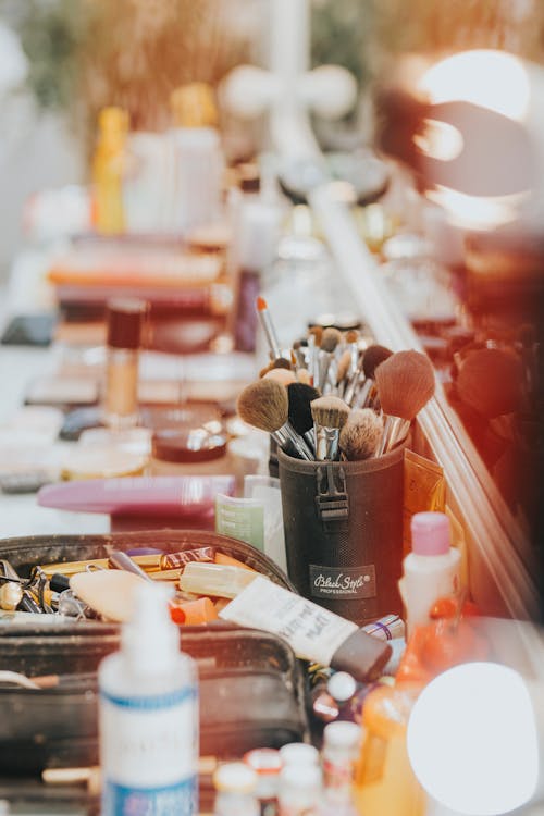 Brushes in Container Among Cosmetics