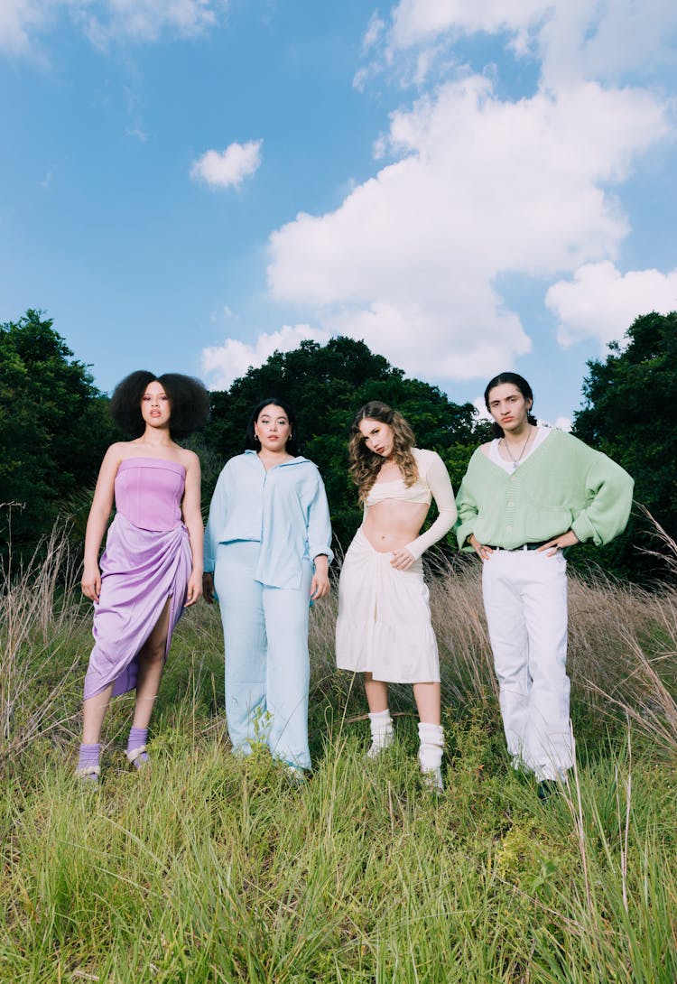 Group Of Models In Pastel Colored Clothing Standing On A Field 