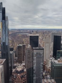 A stunning aerial view of Manhattan's skyscrapers and Central Park on a cloudy day.