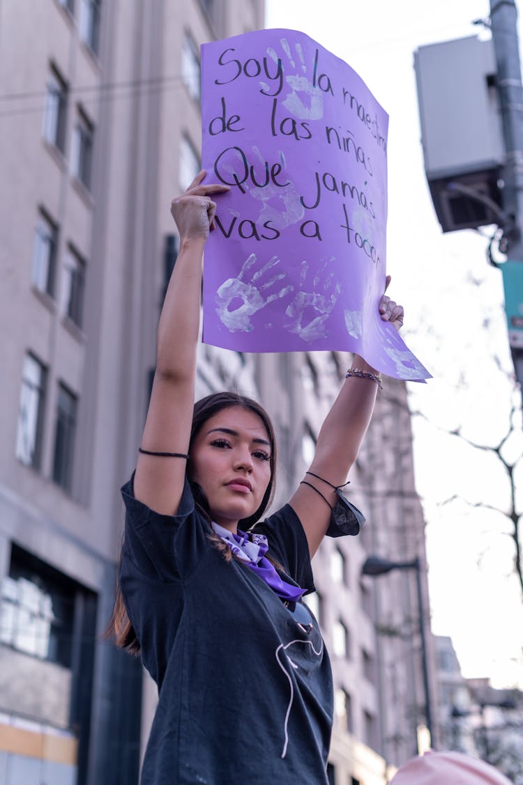 Woman Holding Banner In Raised Arms