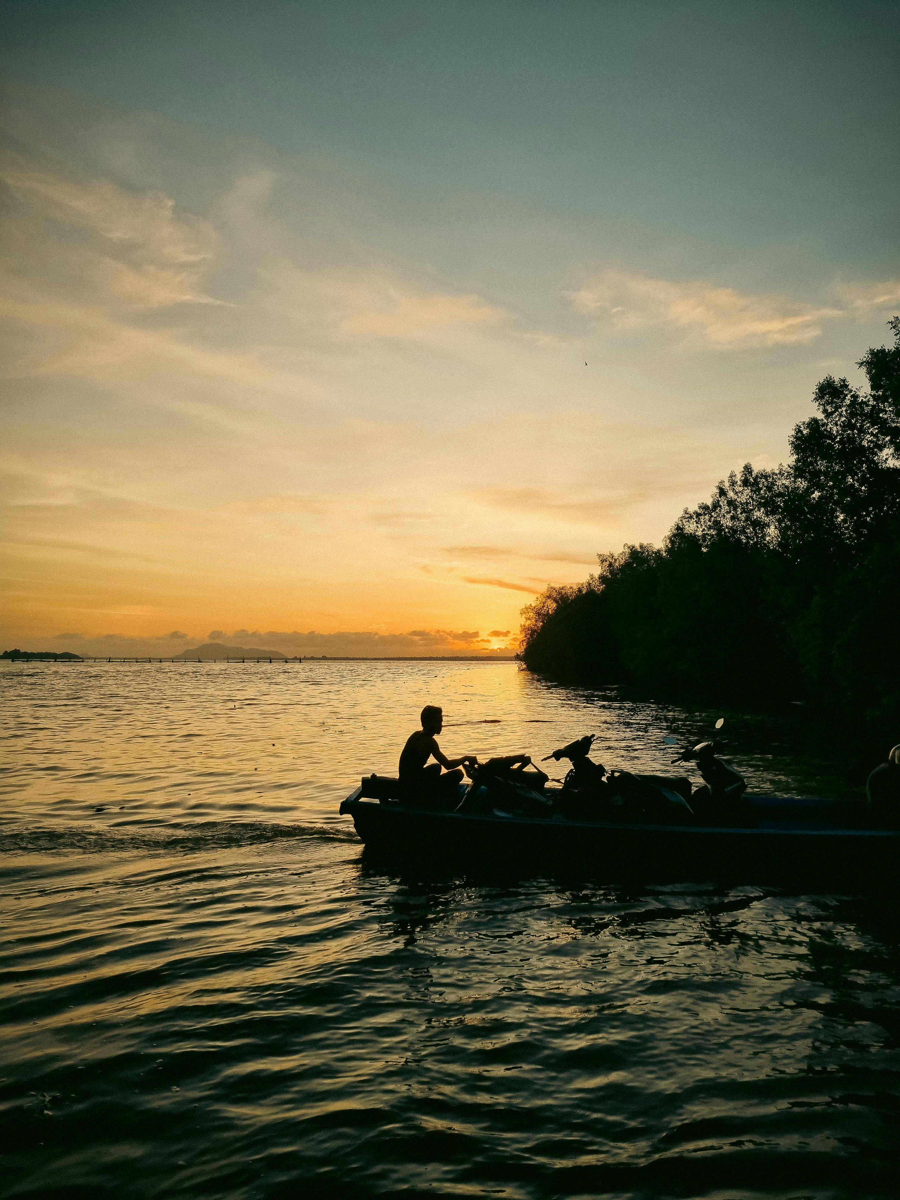 Prescription Goggle Inserts - Peaceful scene of a man rowing a boat at sunset in West Kalimantan, Indonesia.