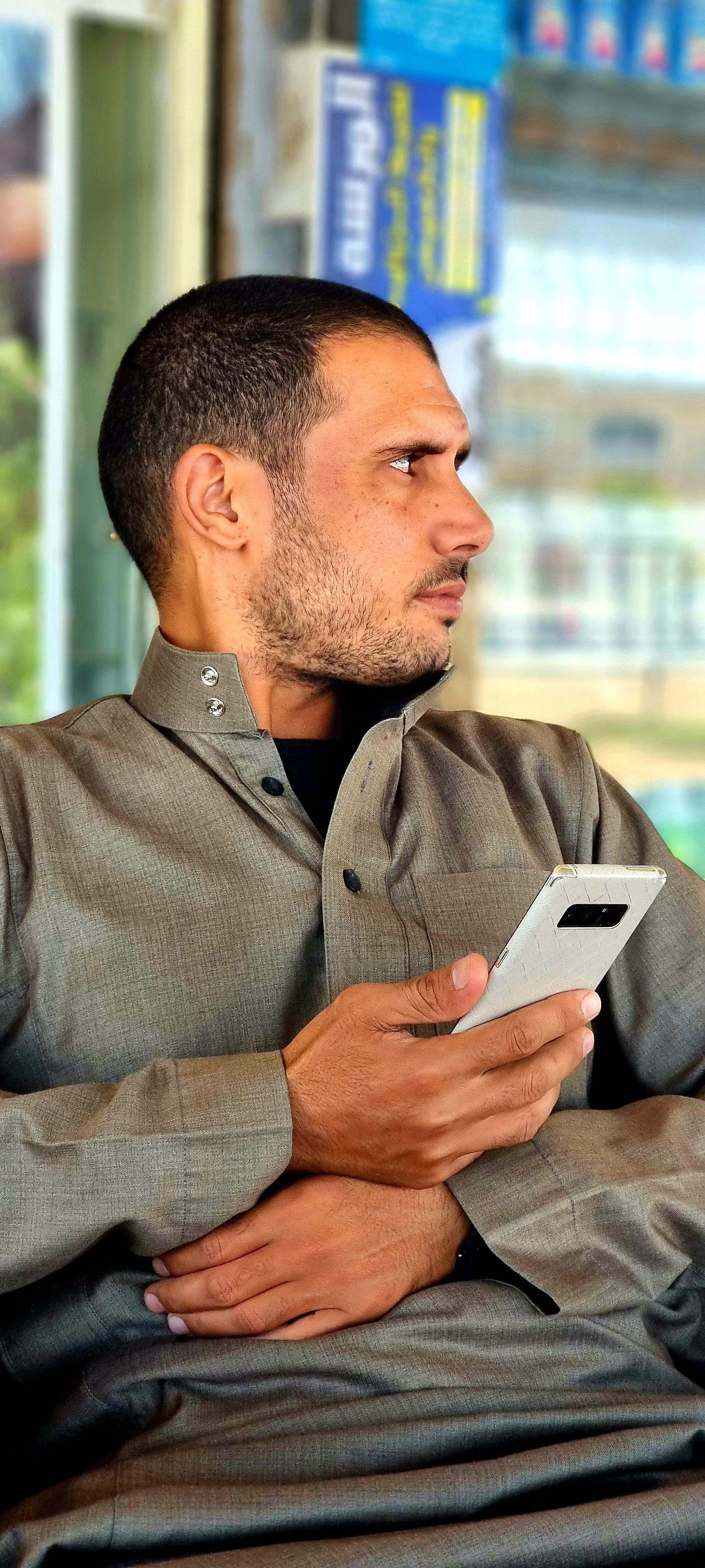 Middle Eastern man using a smartphone in Egypt, captured in a candid portrait.