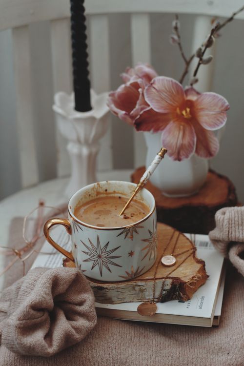 Free Warm setup with coffee, flowers on a wooden coaster, evoking cozy vibes. Stock Photo