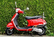 Red and Black Moped Scooter Beside Green Grass
