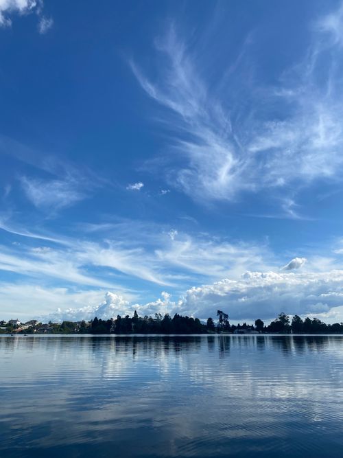 Free Beautiful view of a serene lake with a vibrant blue sky and clouds in Hamilton, New Zealand. Stock Photo