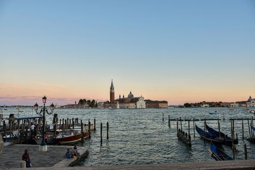 Free Peaceful sunset view of San Giorgio Maggiore with boats in Venice, Italy. Stock Photo