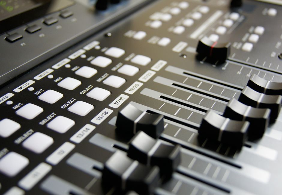 Detailed view of audio mixer sliders and buttons for sound engineering and music production.