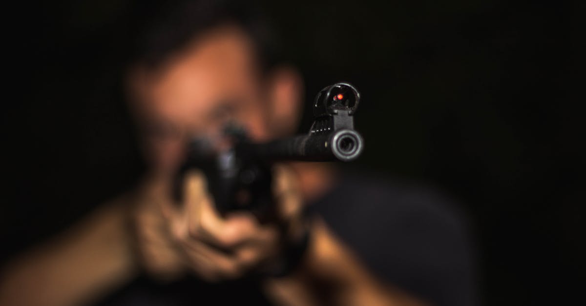 Photo of Man Holding Rifle