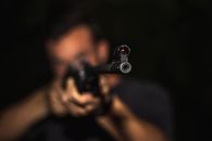 Photo of Man Holding Rifle