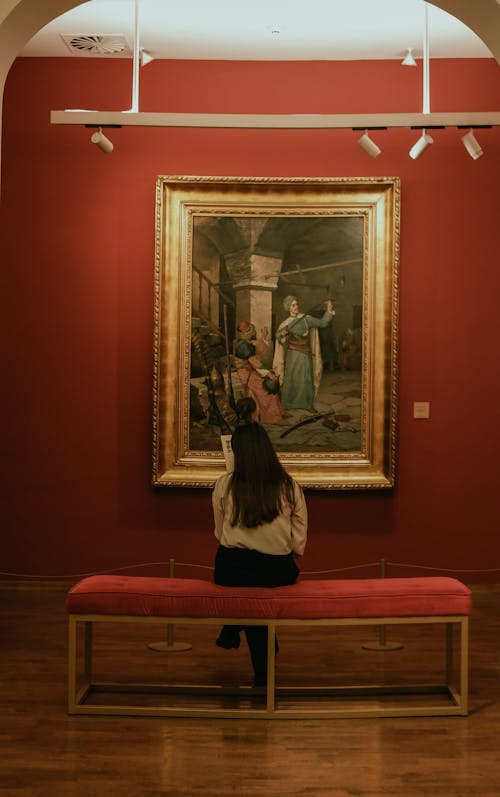 A Woman Looking at a Painting in an Art Gallery