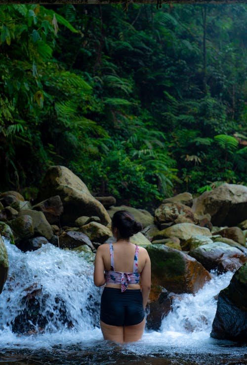 Woman in Front of a Stream in a Jungle 