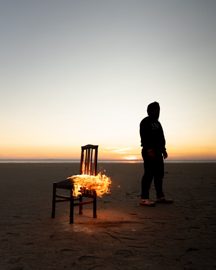 A Burning Chair On A Beach