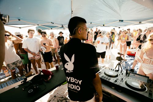A DJ Playing for a Group of People
