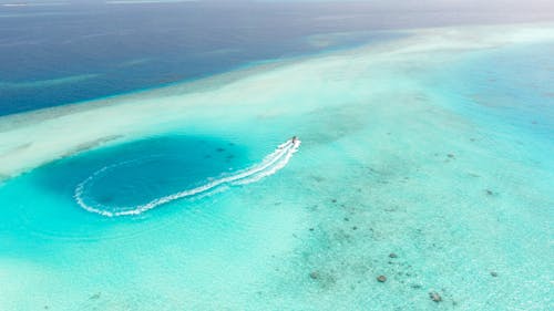 Aerial View of a Motorboat on a Turquoise Ocean