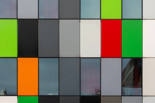 Free Close-up of a colorful modern building facade featuring multi-colored panels in Utrecht, Netherlands. Stock Photo
