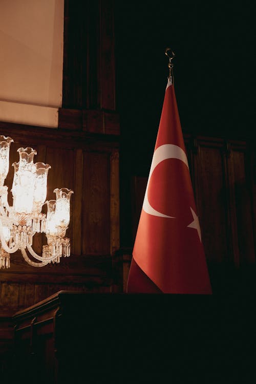 Turkish Flag beside a Glowing Chandelier