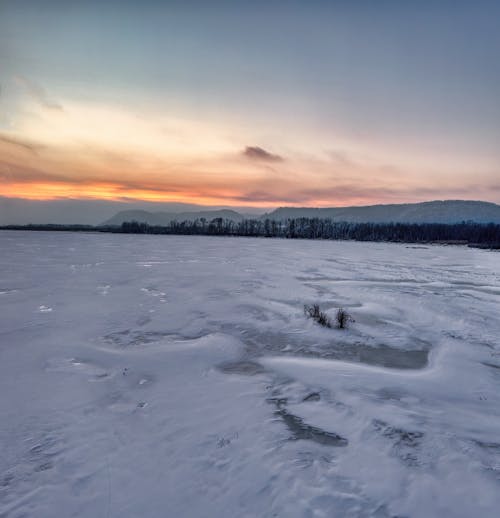 A Frozen Lake Surface under a Sunset Sky 