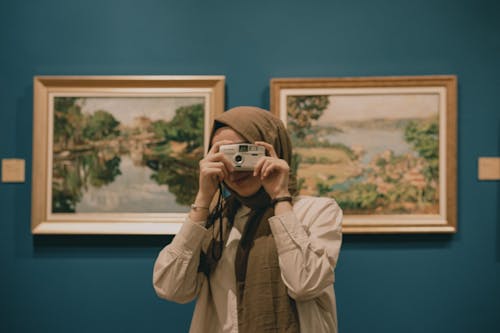 Woman Taking a Photo in an Art Gallery