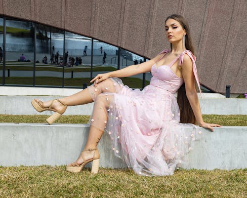 Female Model Wearing a Pink Dress and Platform Heels Posing Outdoors