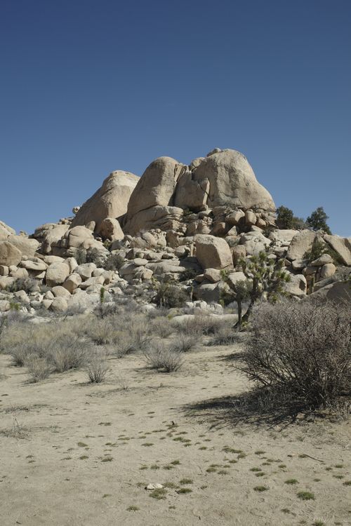 Free Scenic view of unique rock formations under clear blue sky in arid desert environment. Stock Photo