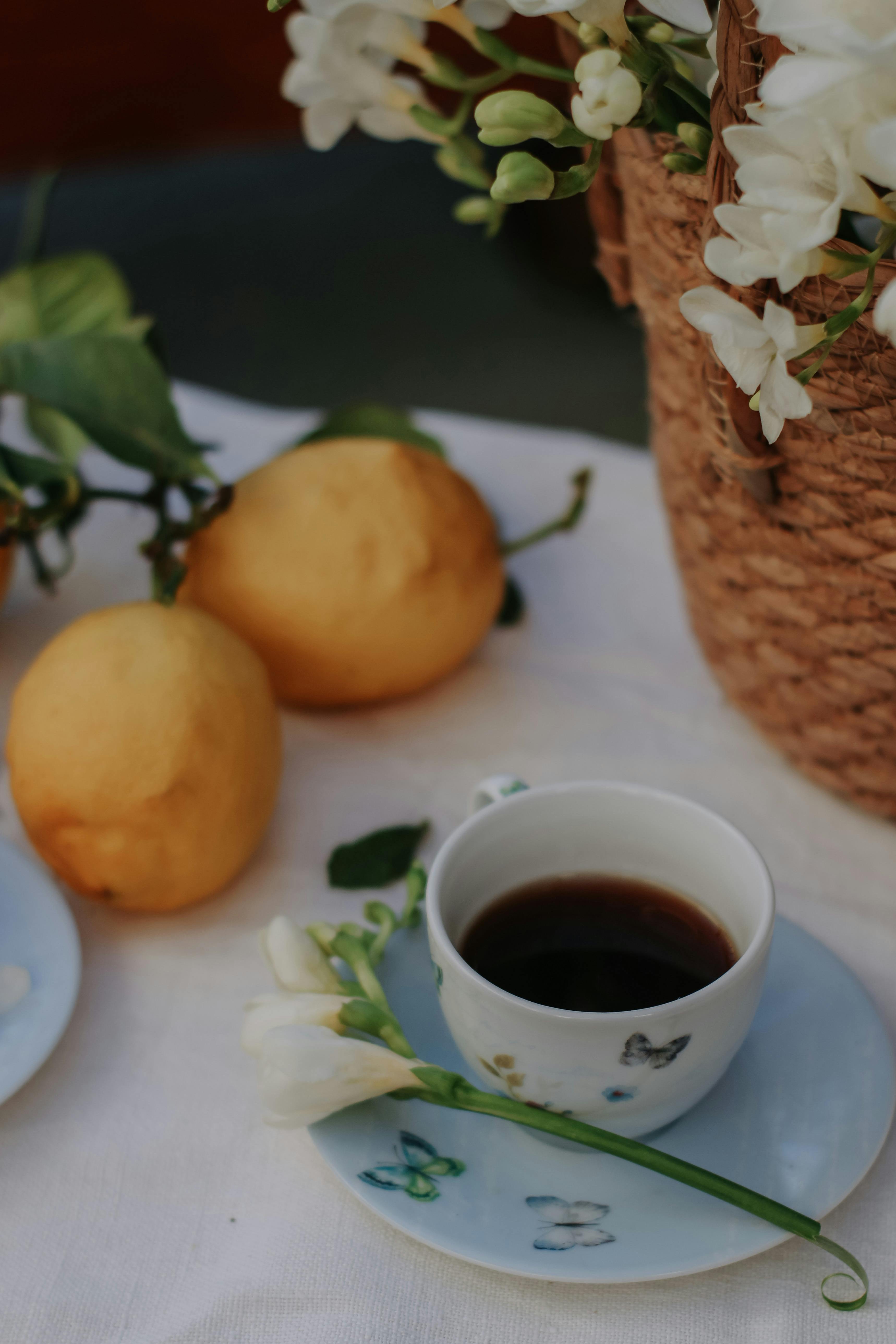 A refined coffee scene with lemons and a floral display, exuding a warm and inviting ambiance.