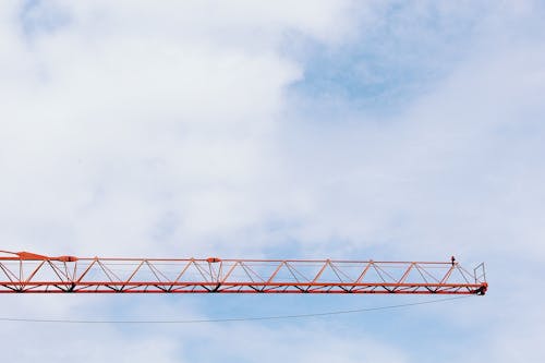 Free Red Crane Photo Under Cloudy Sky during Daytime Stock Photo