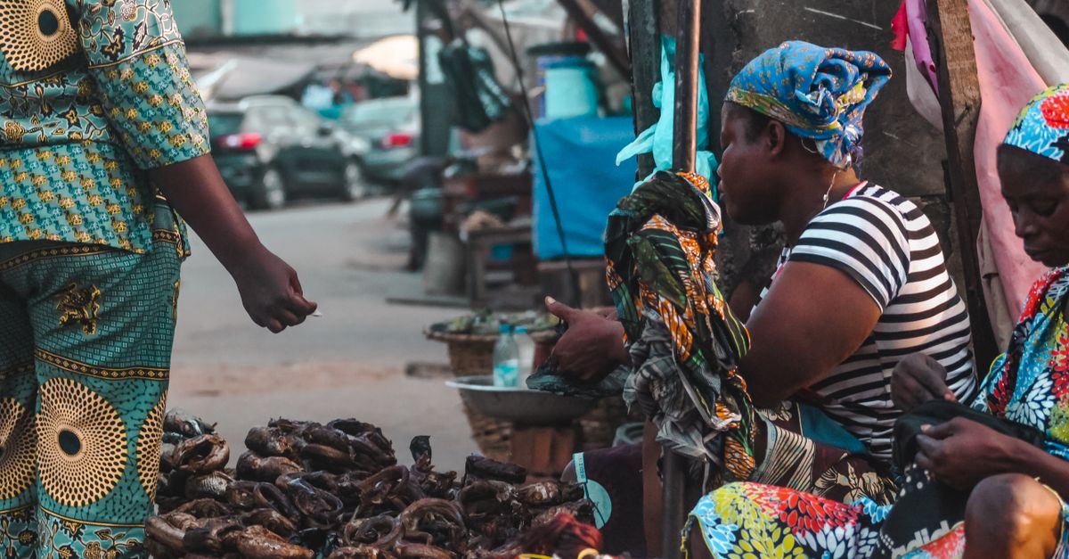 Local vendors selling food and crafts near Christ Embassy Loveworld Arena entrance