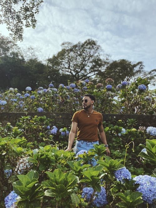 Man Standing in Blossoming Garden