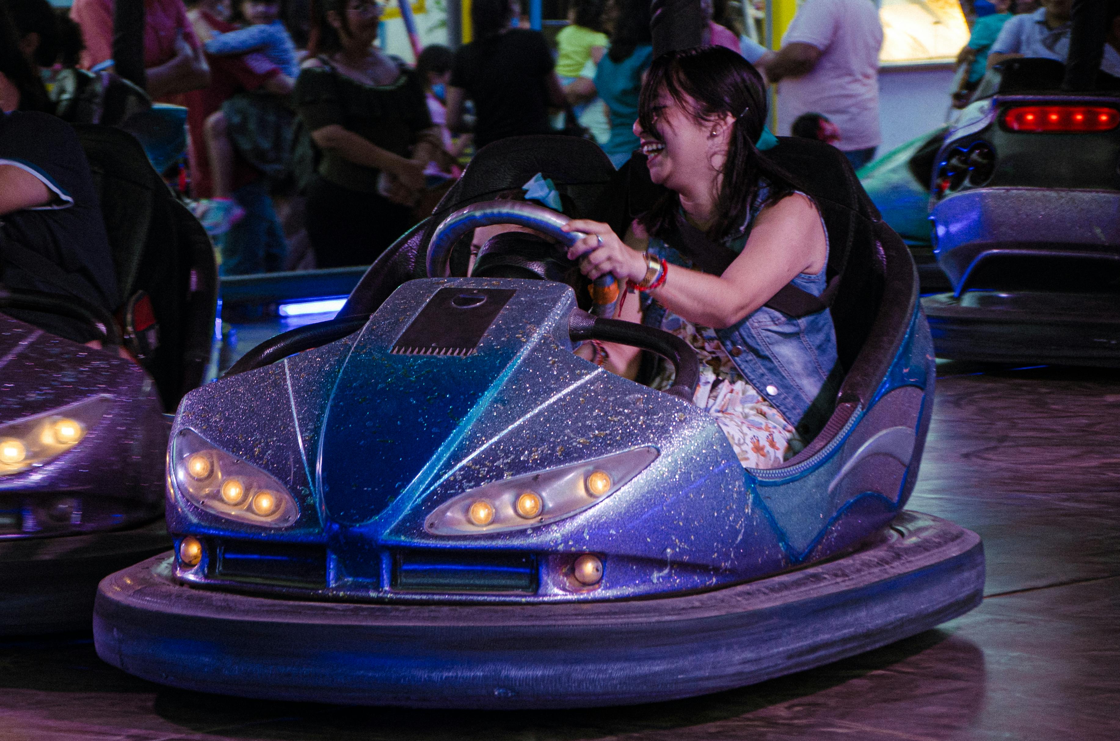 Woman Driving a Bumper Car · Free Stock Photo