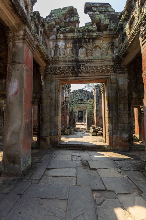 Free View of an ancient stone corridor in Angkor Wat, Cambodia, showcasing historical architecture. Stock Photo