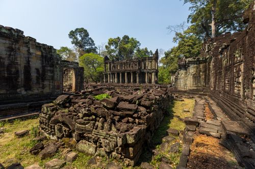 Free Explore the ancient ruins of Angkor Wat temple amidst lush greenery. Stock Photo