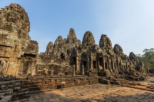 Free Explore the historic Bayon Temple ruins in Angkor Wat under a clear blue sky. Stock Photo