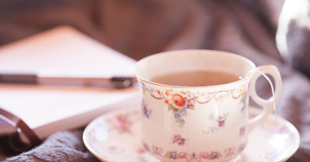 An open notebook with senior living terms circled and connected by lines, next to a cup of tea
