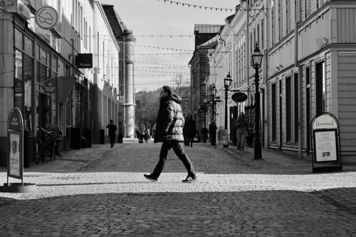 Free Monochrome view of a cobblestone street in Jönköping, Sweden showcasing walking pedestrians. Stock Photo