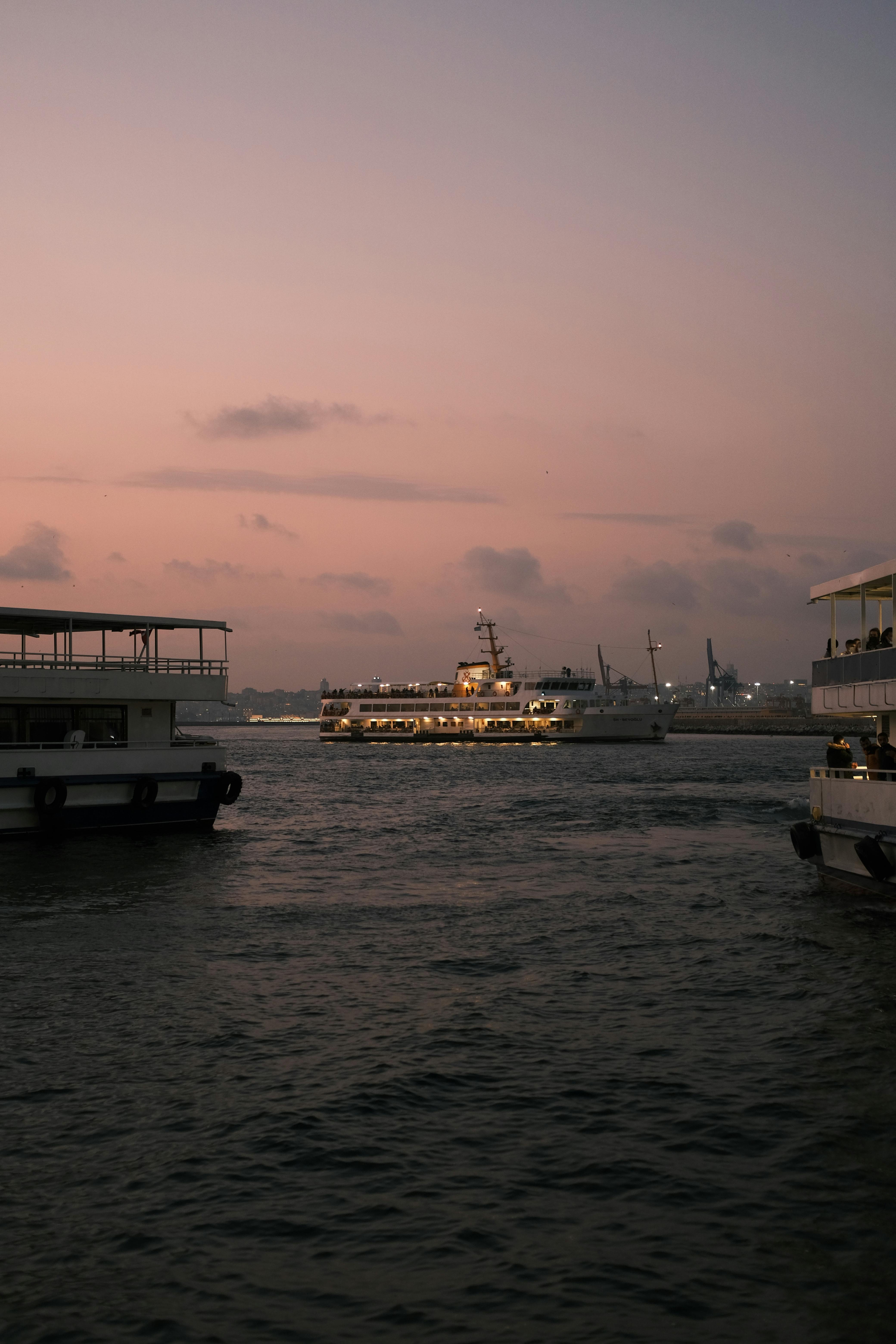 Peaceful twilight harbor scene with ferries floating under a calm dusk sky.