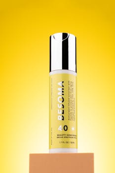 High-quality beauty sunscreen bottle with bright yellow backdrop for skincare product promotion.