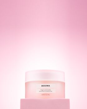 Bright and elegant BESOMA moisturizer jar on a soft pink background, perfect for skincare promotions.