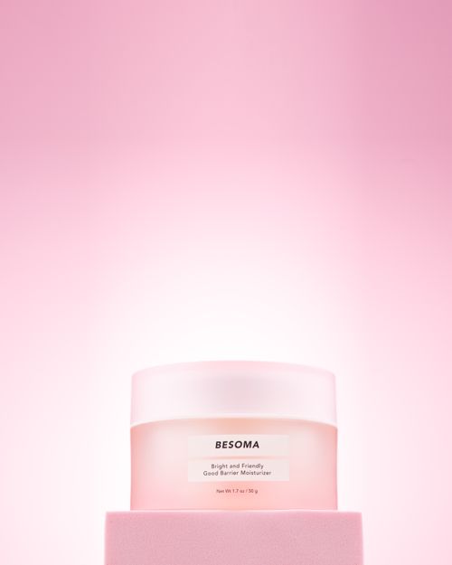 Free Bright and elegant BESOMA moisturizer jar on a soft pink background, perfect for skincare promotions. Stock Photo