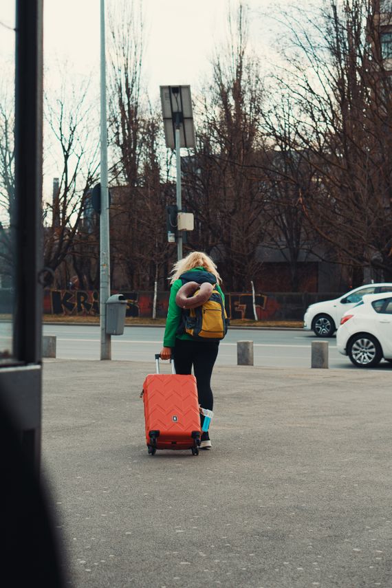 Traveler walking through the city with a suitcase