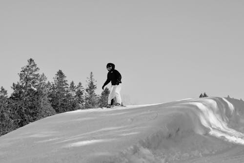 Black and White Photo of a Person Skiing on a Slope 