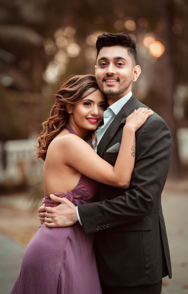 Smiling Couple In Formal Wear Hugging Outdoors