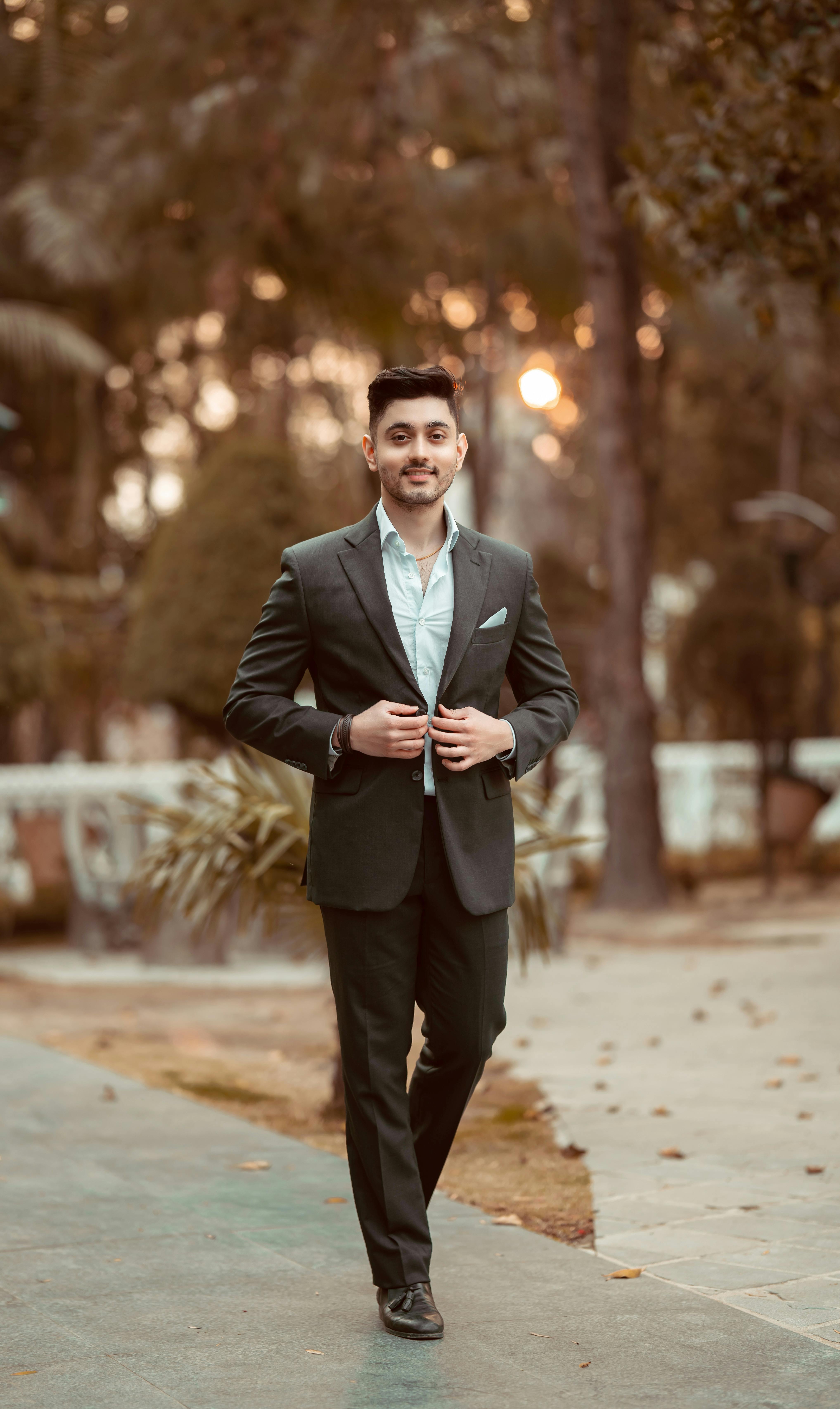 Elegant Young Handsome Man Posing In Fashionable Suit. Studio Shot. Stock  Photo, Picture and Royalty Free Image. Image 64307941.