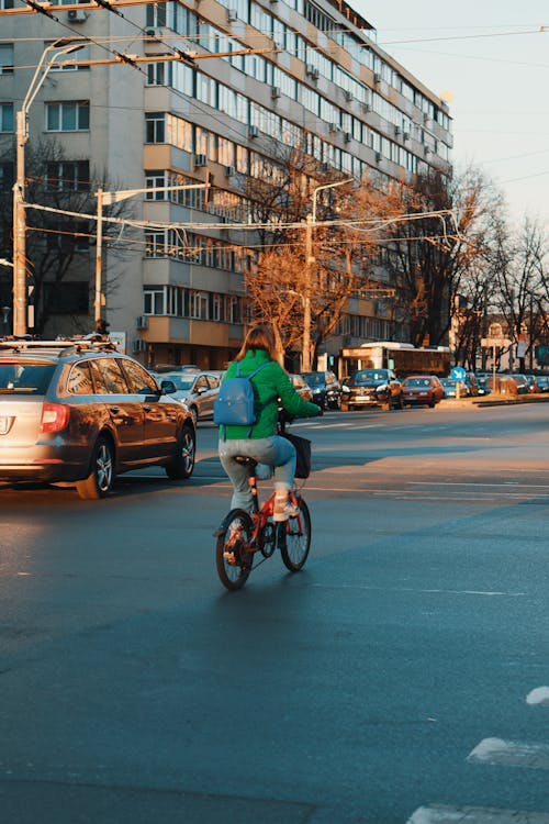 Back View of a Woman Riding a Bicycle on a Road