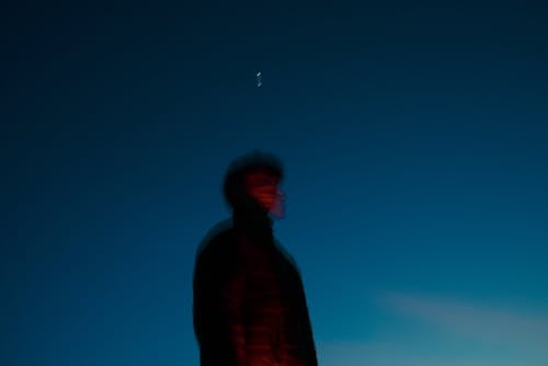 Blurry Picture of a Man Against a Clear Sky at Dusk 