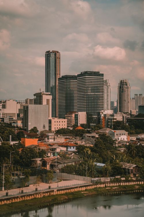 Free Urban skyline view of Jakarta, Indonesia with skyscrapers by the river. Stock Photo