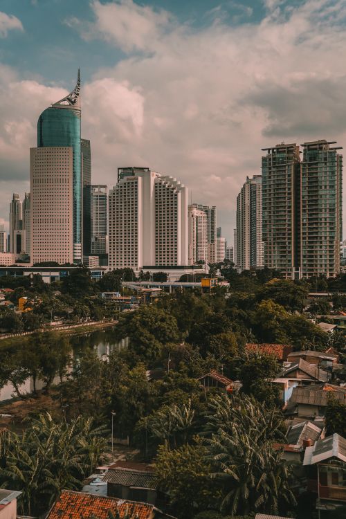 Free A stunning view of Jakarta's modern skyscrapers against a cloudy sky, showcasing urban architecture. Stock Photo